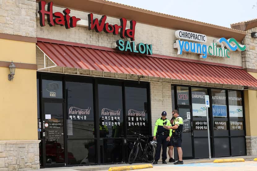 Police stand outside Hair World Salon on Tuesday, May 17, 2022 in Dallas, Texas. Dallas...
