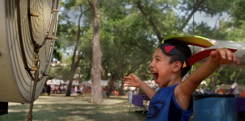 Edward Avila of Dallas cooled off in front of a fan at the Pepsi KidAround at Reverchon Park...
