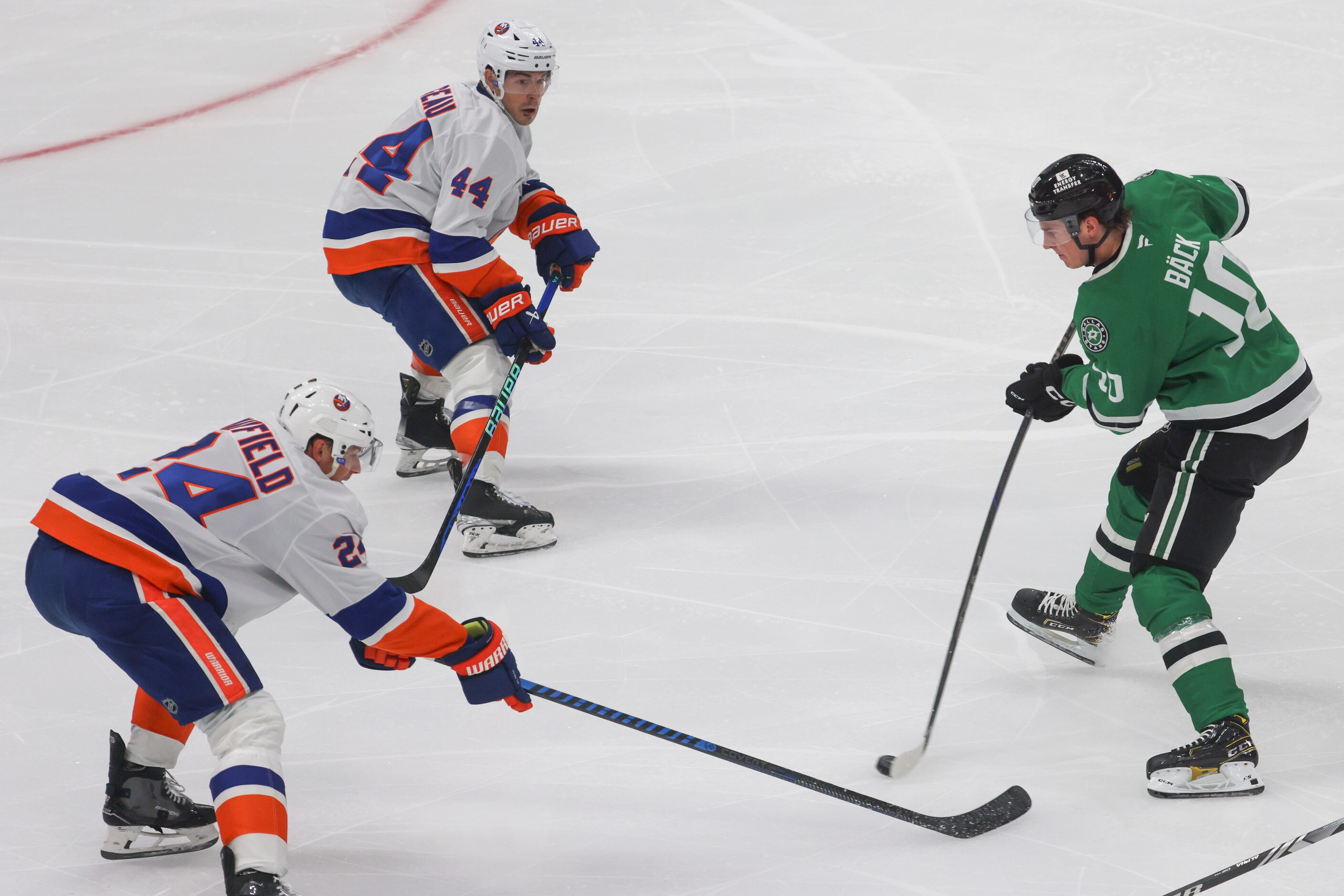 Dallas Stars center Oskar Bäck (right) goes against New York Islanders defenseman Scott...