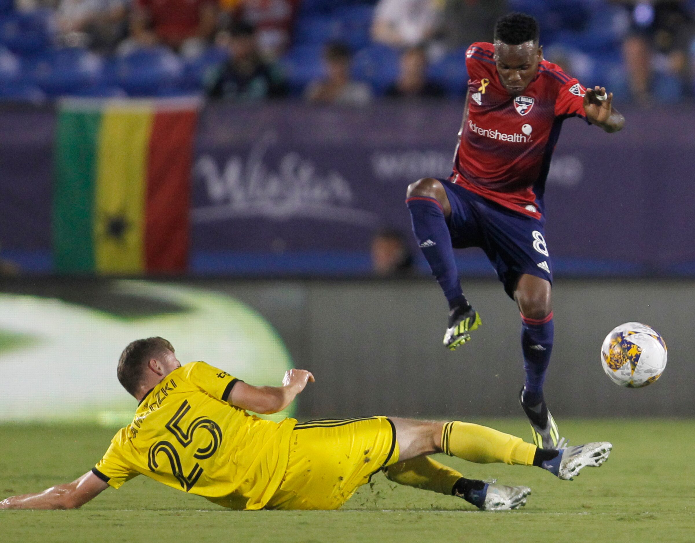 FC Dallas attacker Jader Obrian (8) leaps to avoid colliding with Columbus defender Sean...