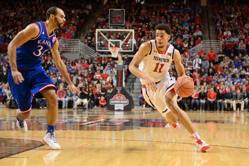 LUBBOCK, TX - JANUARY 09: Zach Smith #11 of the Texas Tech Red Raiders drives around Perry...