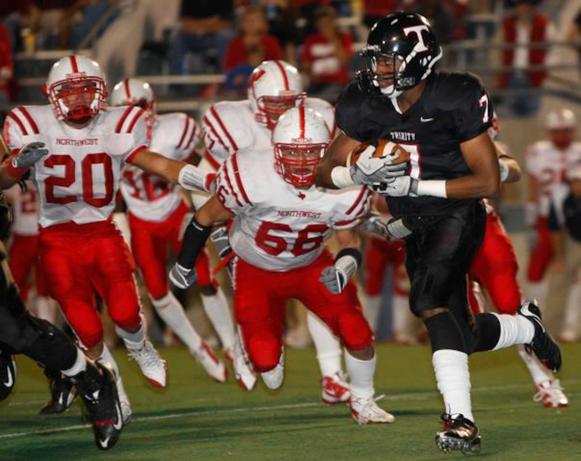 Euless Trinity sophomore running back Tevin Williams (7) tries to escape Justin Northwest...