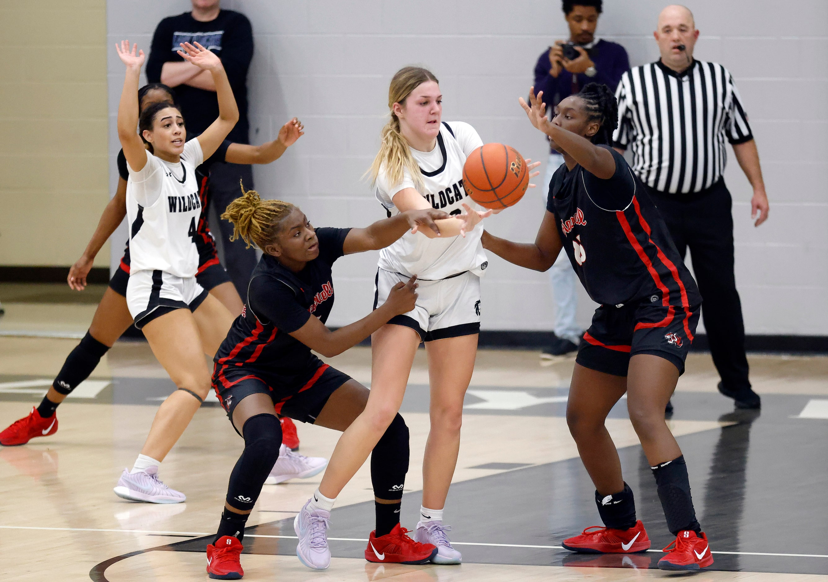 Denton Guyer forward Audrey Mitchell (12) is fouled by Denton Braswell’s Italy Lewis (0) and...