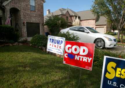 Riner pulls out of her drive past political signs supporting Donald Trump and Pete Sessions...
