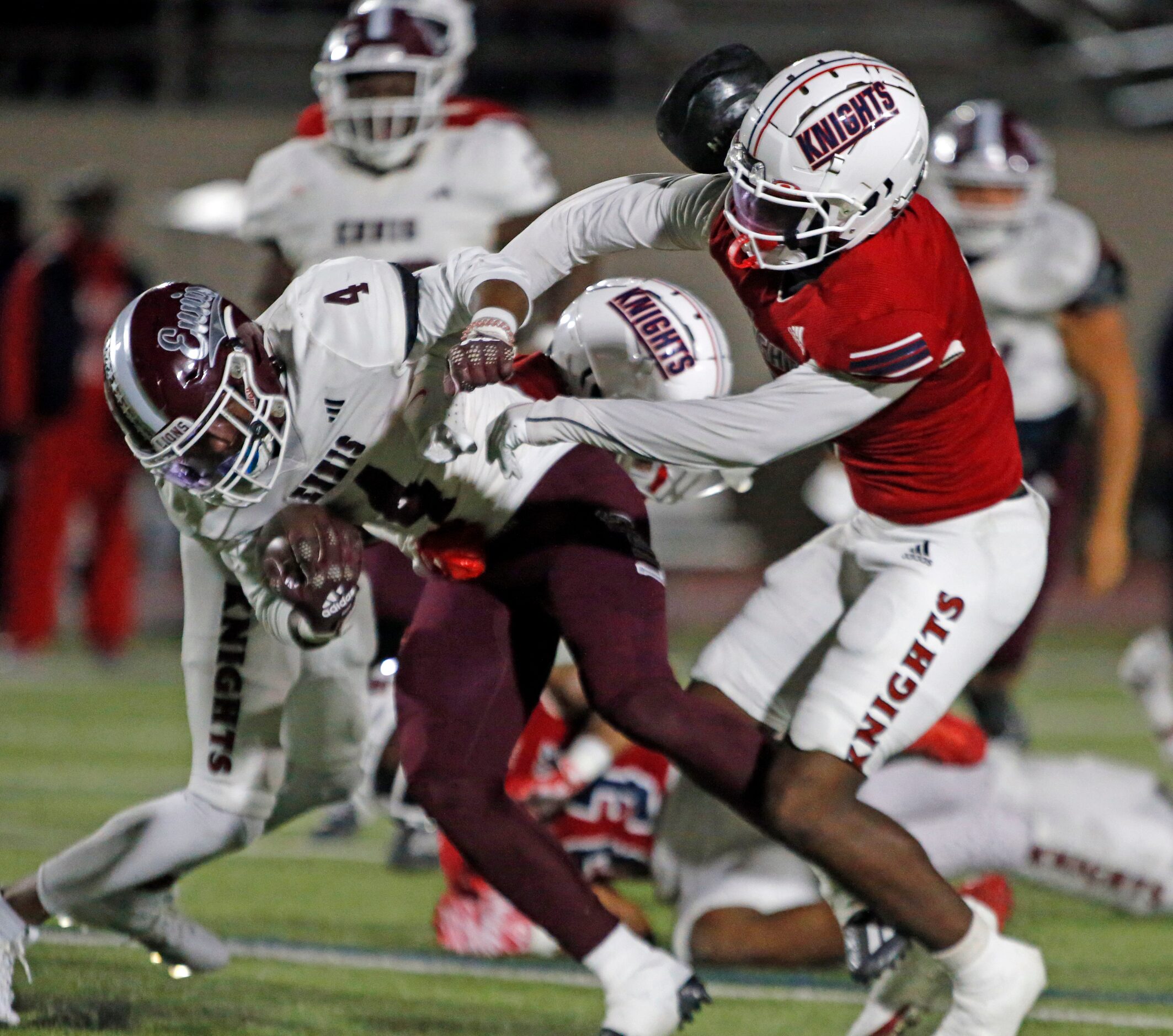 Ennis RB Jeremy Brown Jr. (4, left) gets yardage in heavy traffic during the first half of a...