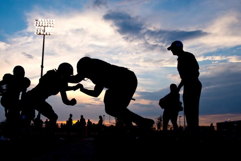  College Station High School football players warm up before a high school football game...