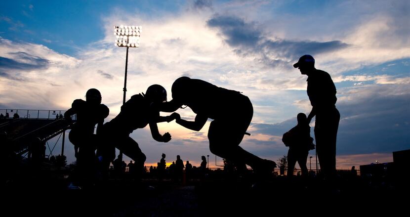 College Station High School football players warm up before a high school football game...