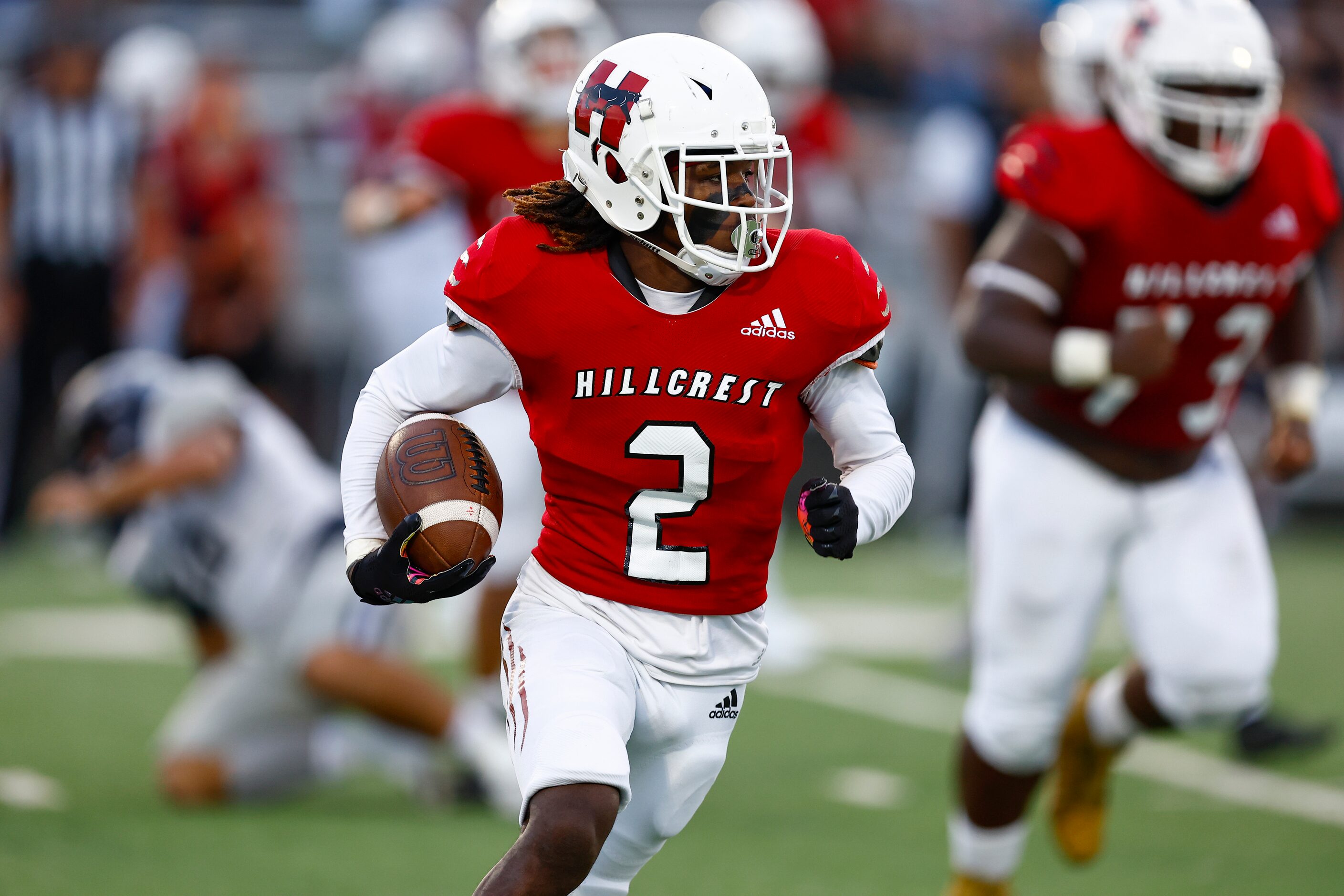 Hillcrest senior running back Reggie Williams (2) looks for room against the Carrollton...