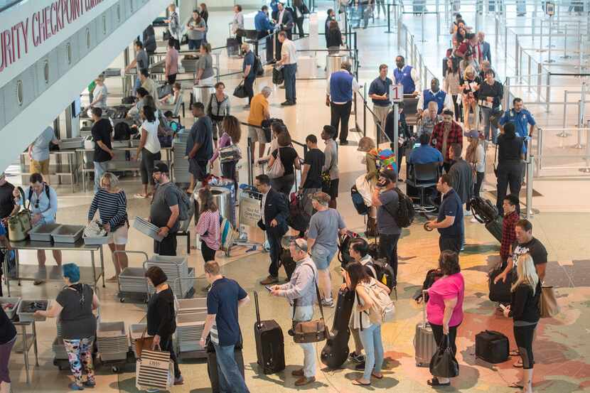 Airline Passengers wait in the security line at Dallas Love Field on Wednesday, May 23.