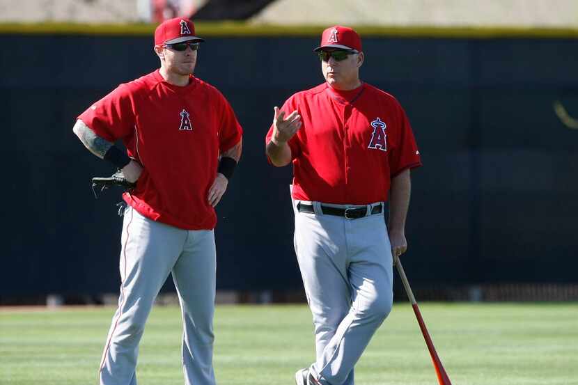 In this Feb. 20, 2014, file photo, Los Angeles Angels left fielder Josh Hamilton, left,...