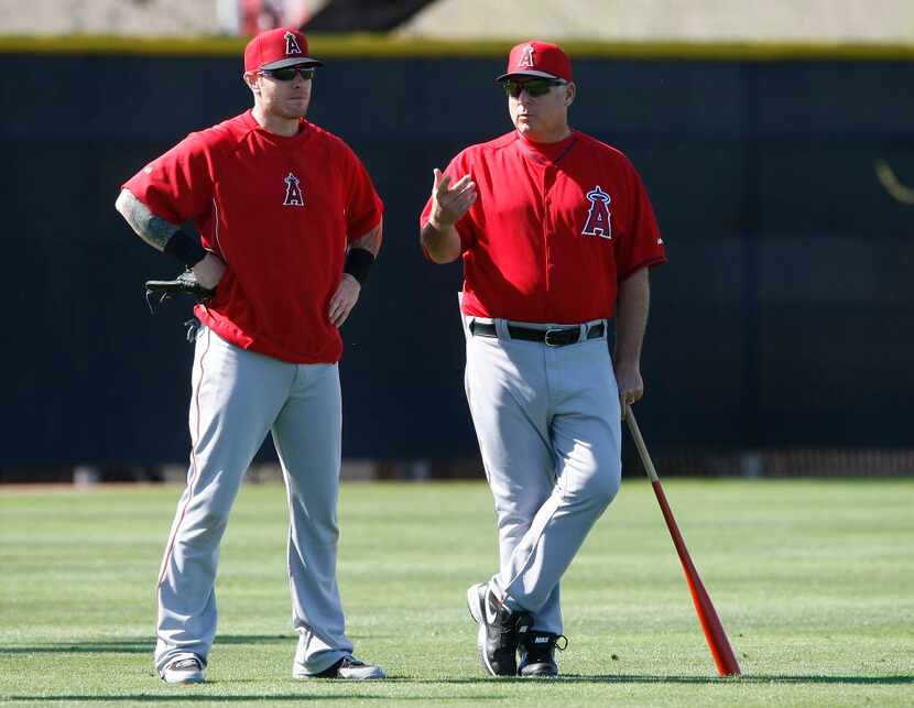 In this Feb. 20, 2014, file photo, Los Angeles Angels left fielder Josh Hamilton, left,...