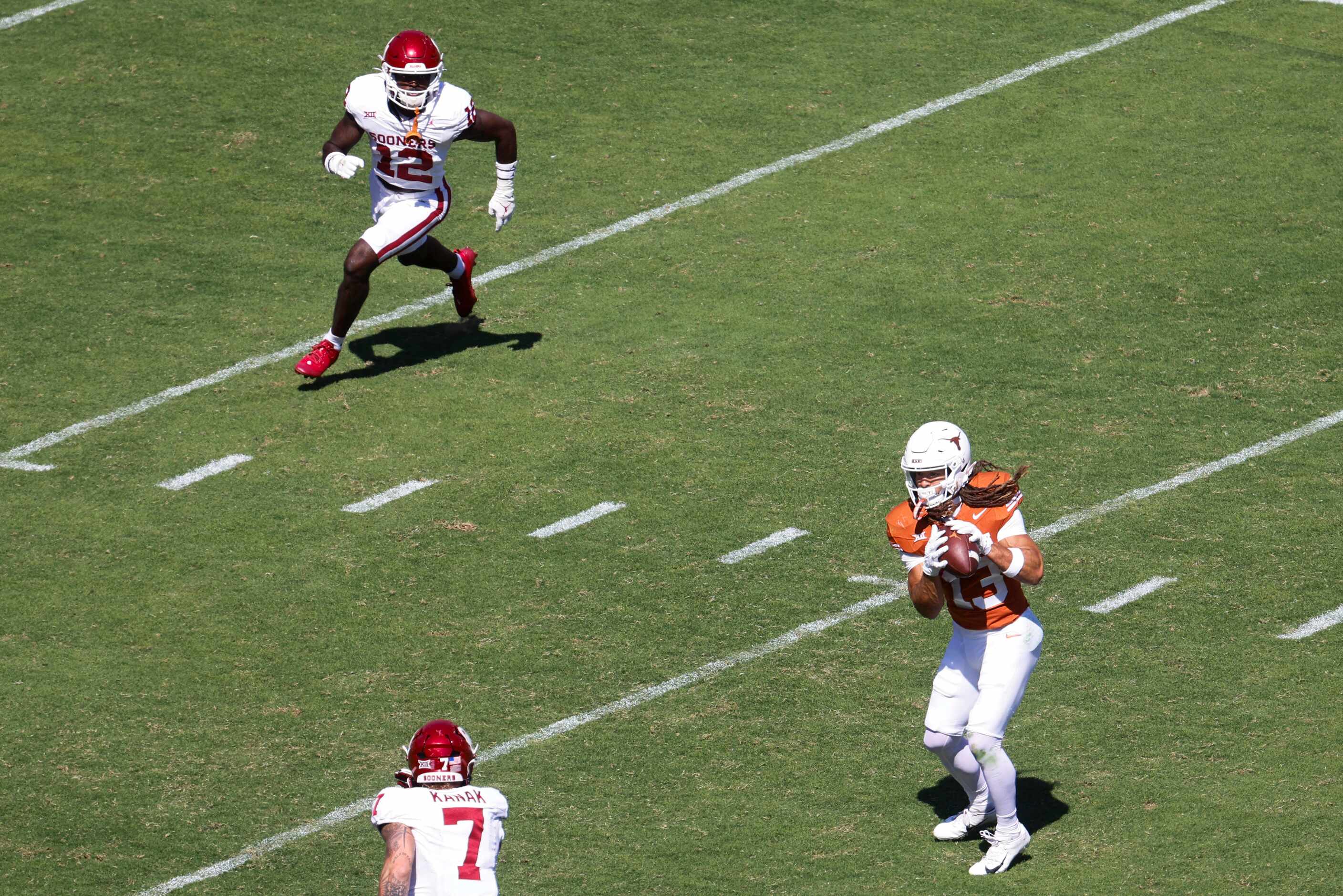 Texas wide receiver Jordan Whittington (right) tries to run against Oklahoma linebacker...