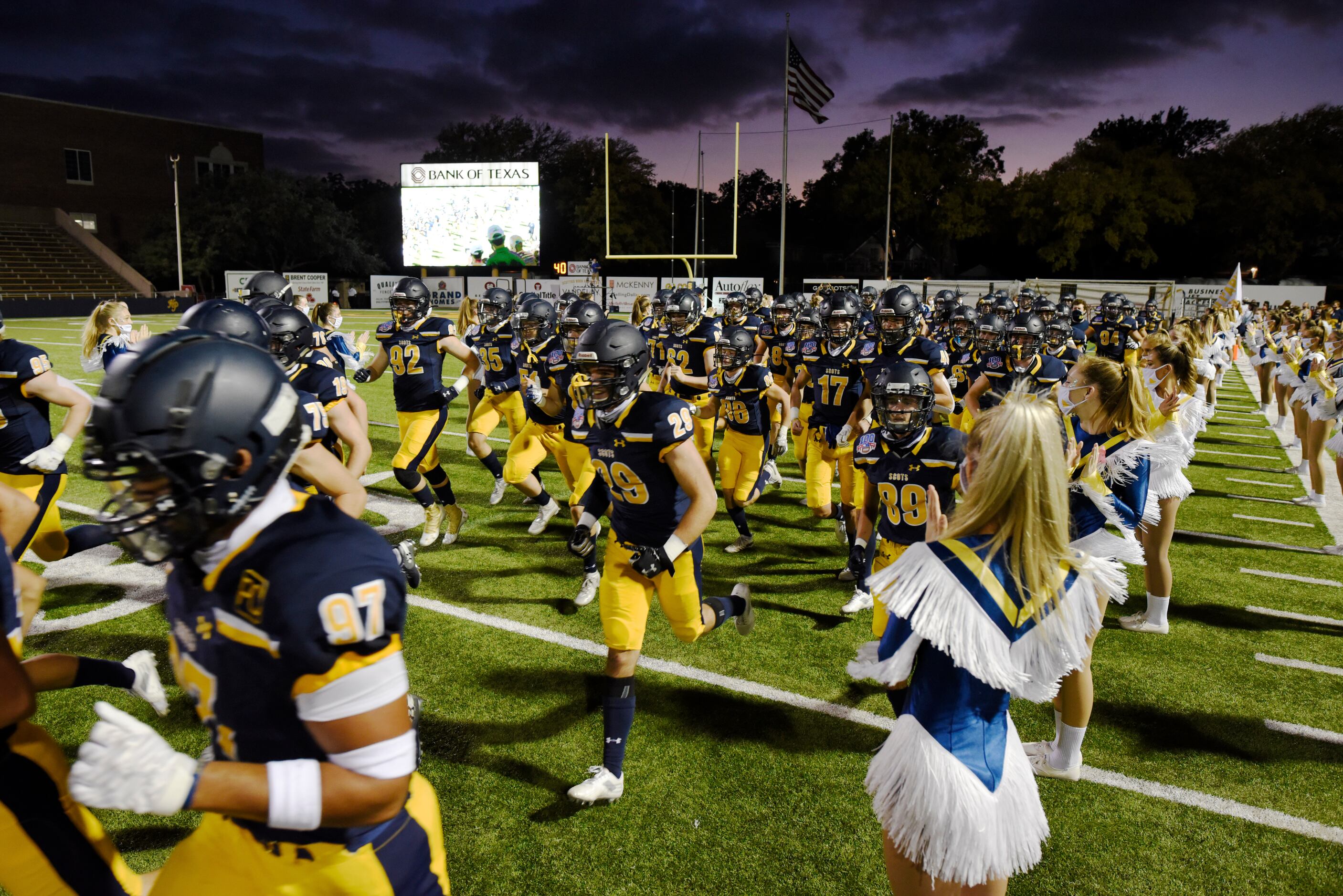 The Highland Park varsity football team runs on to the field for their game versus Coppell...