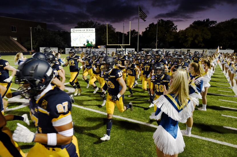 The Highland Park varsity football team runs on to the field for their game versus Coppell...
