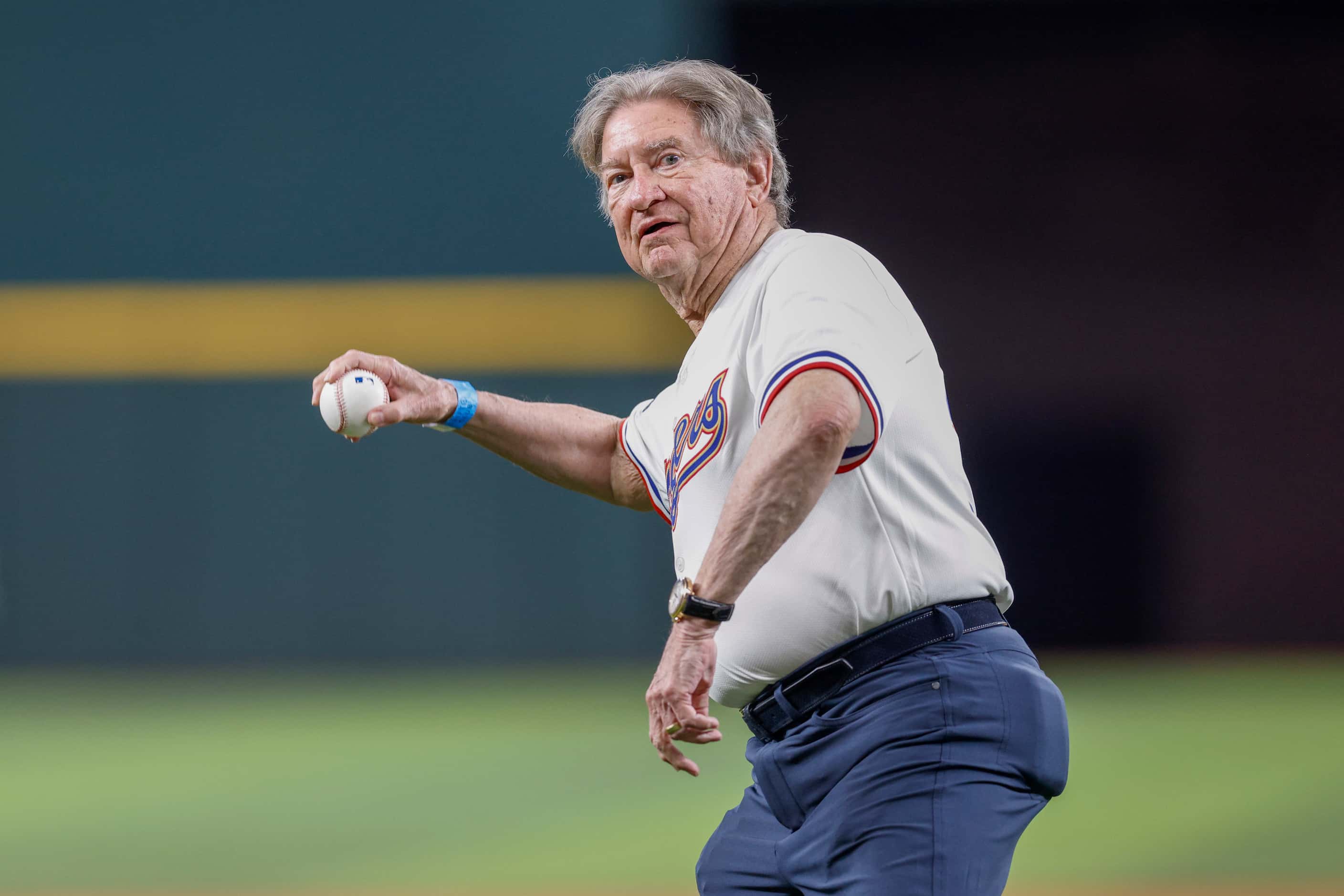 Texas Rangers fan Michael Carter throws the ceremonial first pitch to Texas Rangers Hall of...