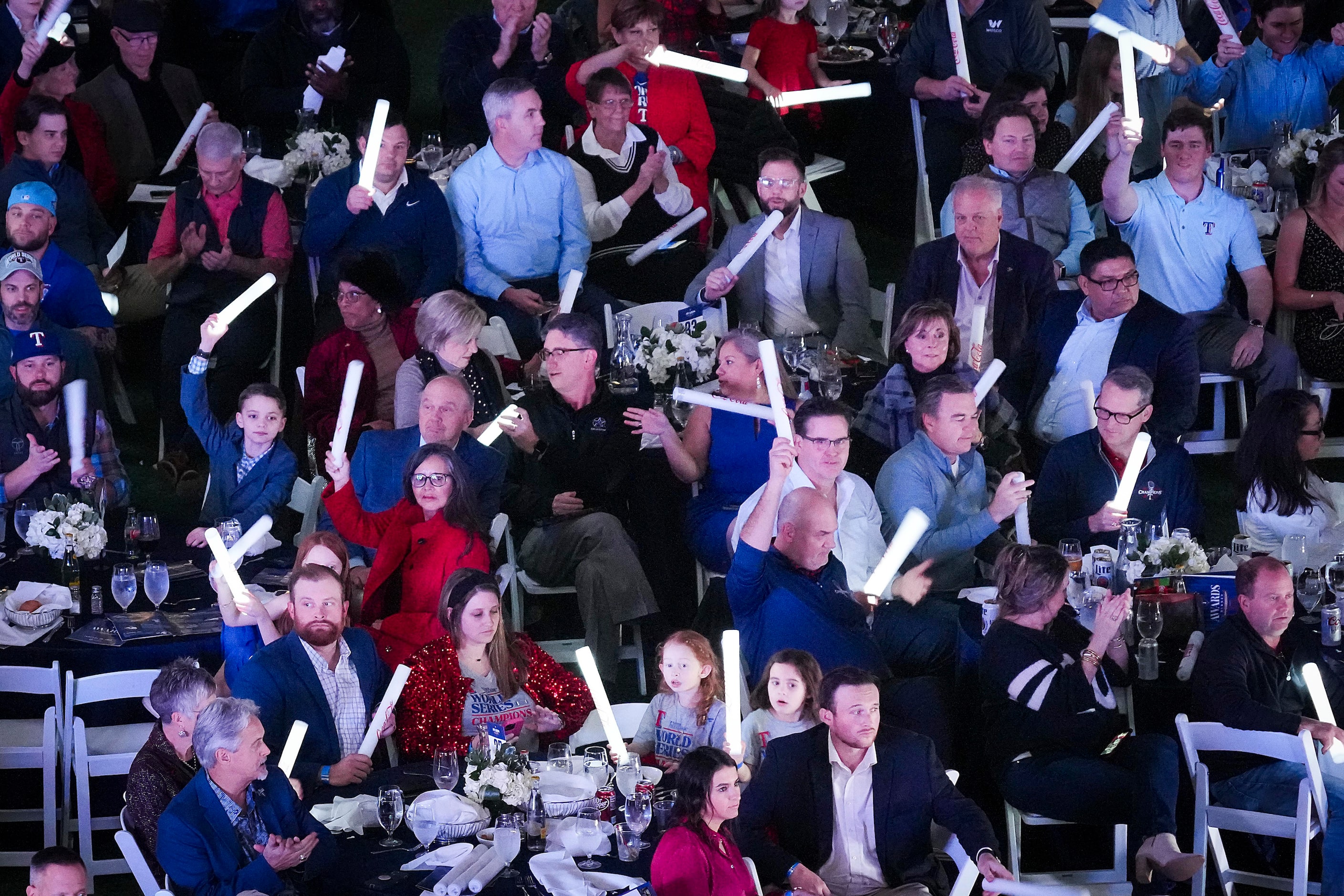 Guests cheer as players are introduced during the Texas Rangers annual awards dinner at...