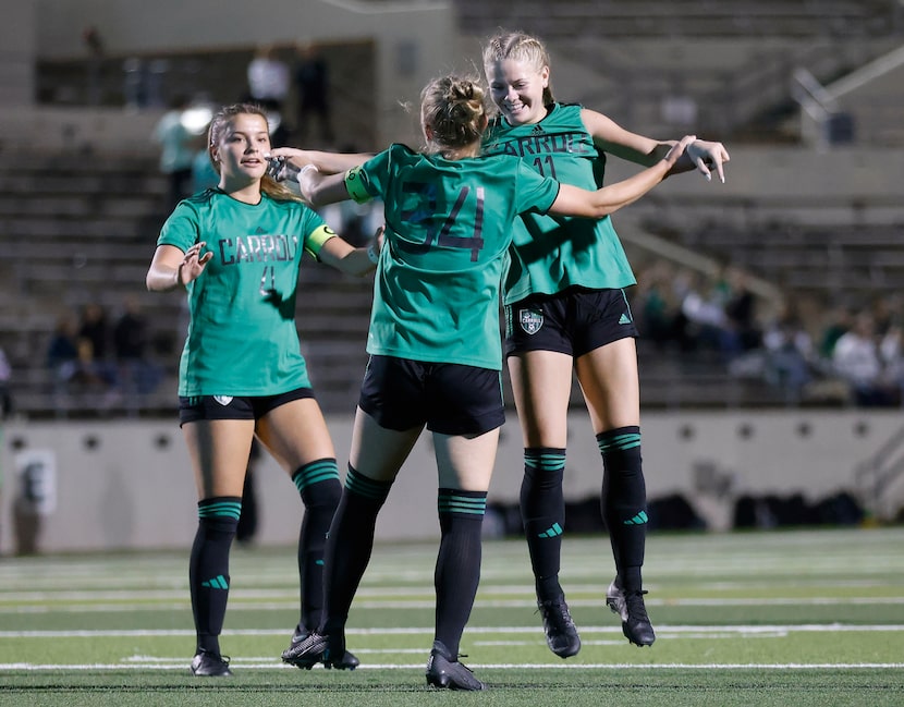 Southlake Carroll midfielder Hannah Jordan (34) is congratulated by Olivia Holcombe (11) and...