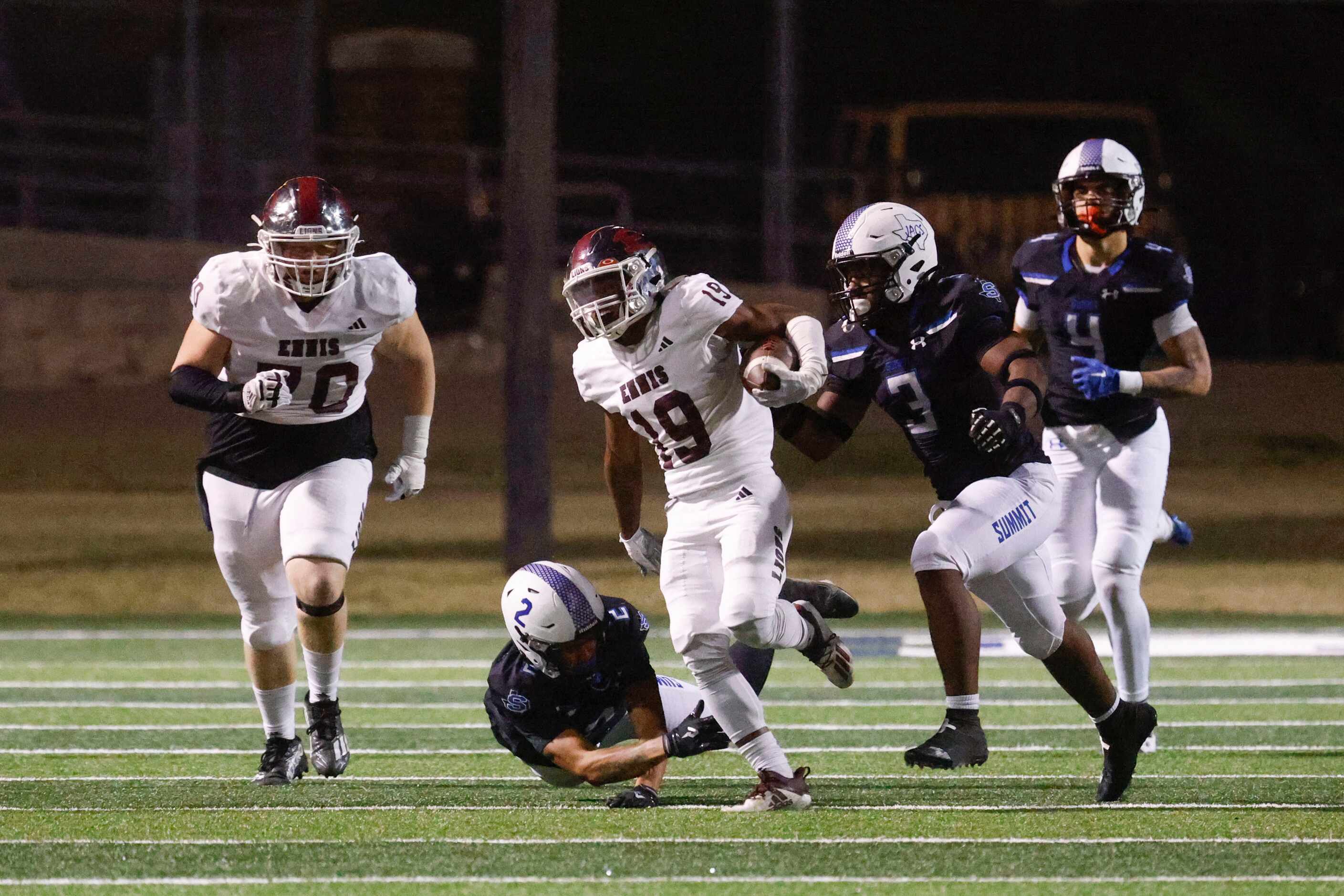 Ennis High’s Jamarquez Farsee (19) is charged by Mansfield Summit high’s Jordan Hubbard (3)...