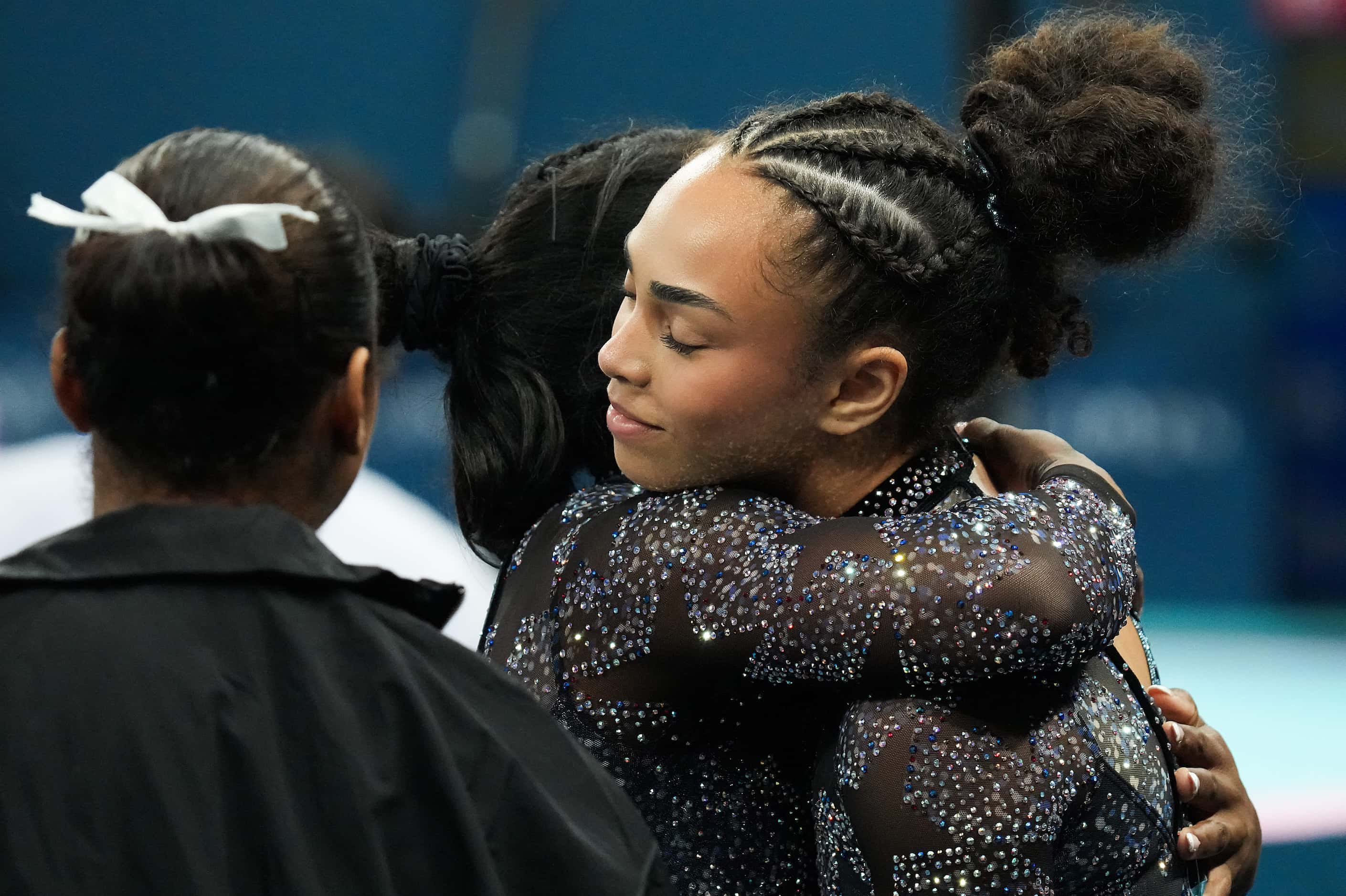 Hezly Rivera of the United States gets a hug from teammate Simone Biles after competing on...
