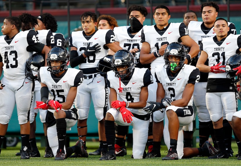 Several Euless Trinity football players including Pofele Ashlock (15), Max Bosilikwa (4) and...