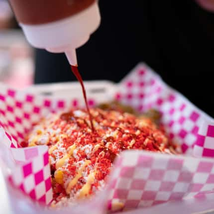 Jesus Perez prepares a "loaded elote tray" at Me Enloteces in Oak Cliff.