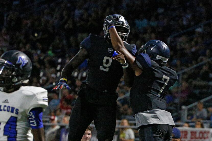 Wylie East's Eno Benjamin (5 -wearing 8) and Corey Eggins (7) celebrate a  touch down...