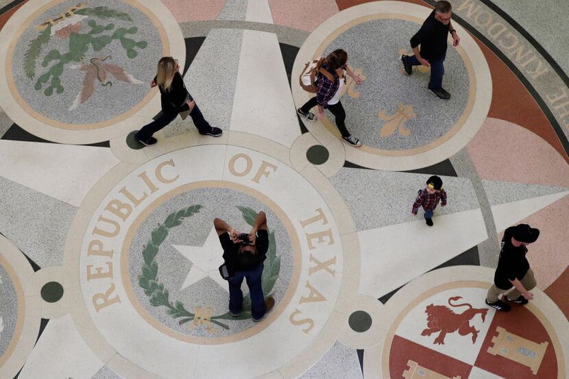 Guest pass through the rotunda at the Texas State Capitol, Monday, Jan. 7, 2019, in Austin,...