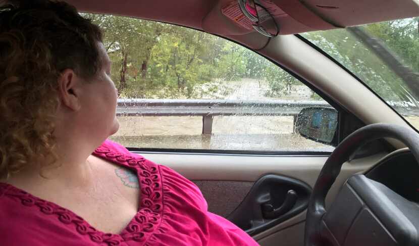 Melinda Castillo checks the water level of Dry Creek just a few yards from her home in...