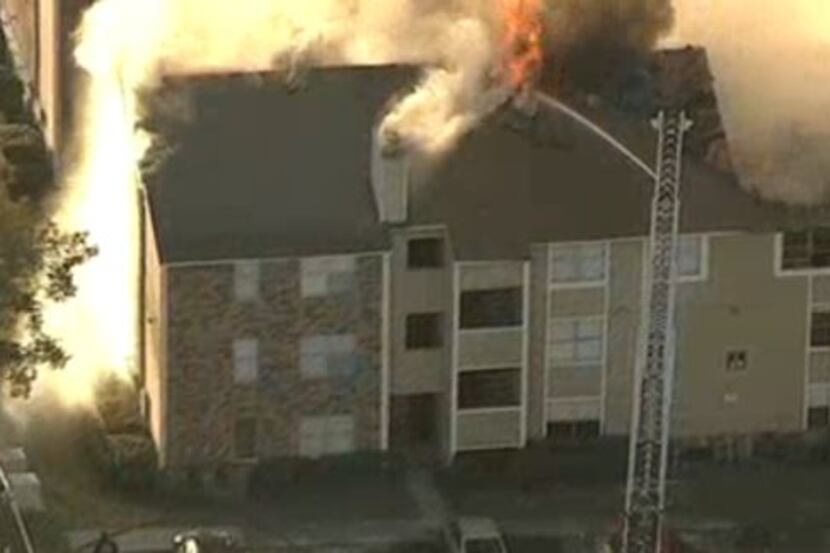Smoke and flames pour from an apartment complex Wednesday morning in Far East Dallas.