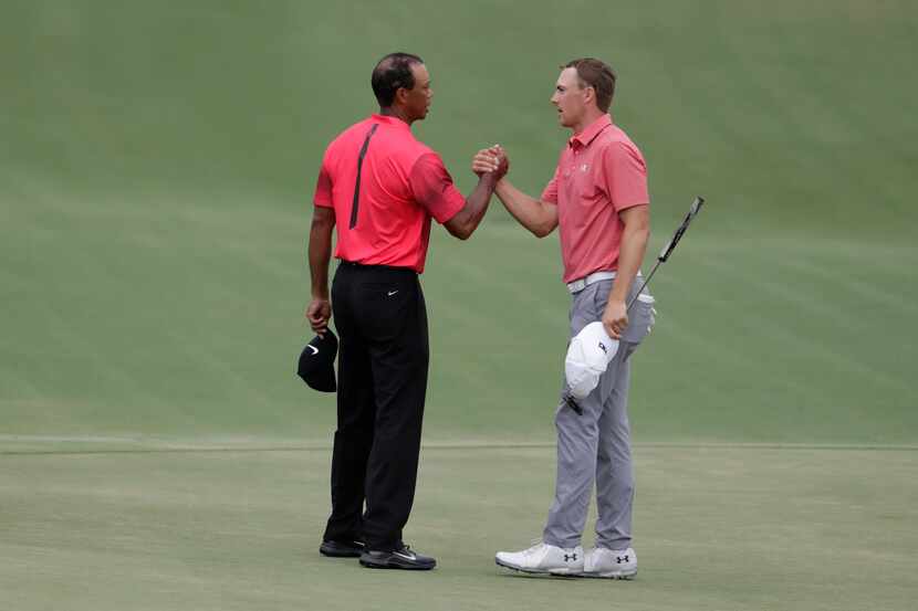 Tiger Woods, left, shakes hands with Jordan Spieth after the final round of the Players...