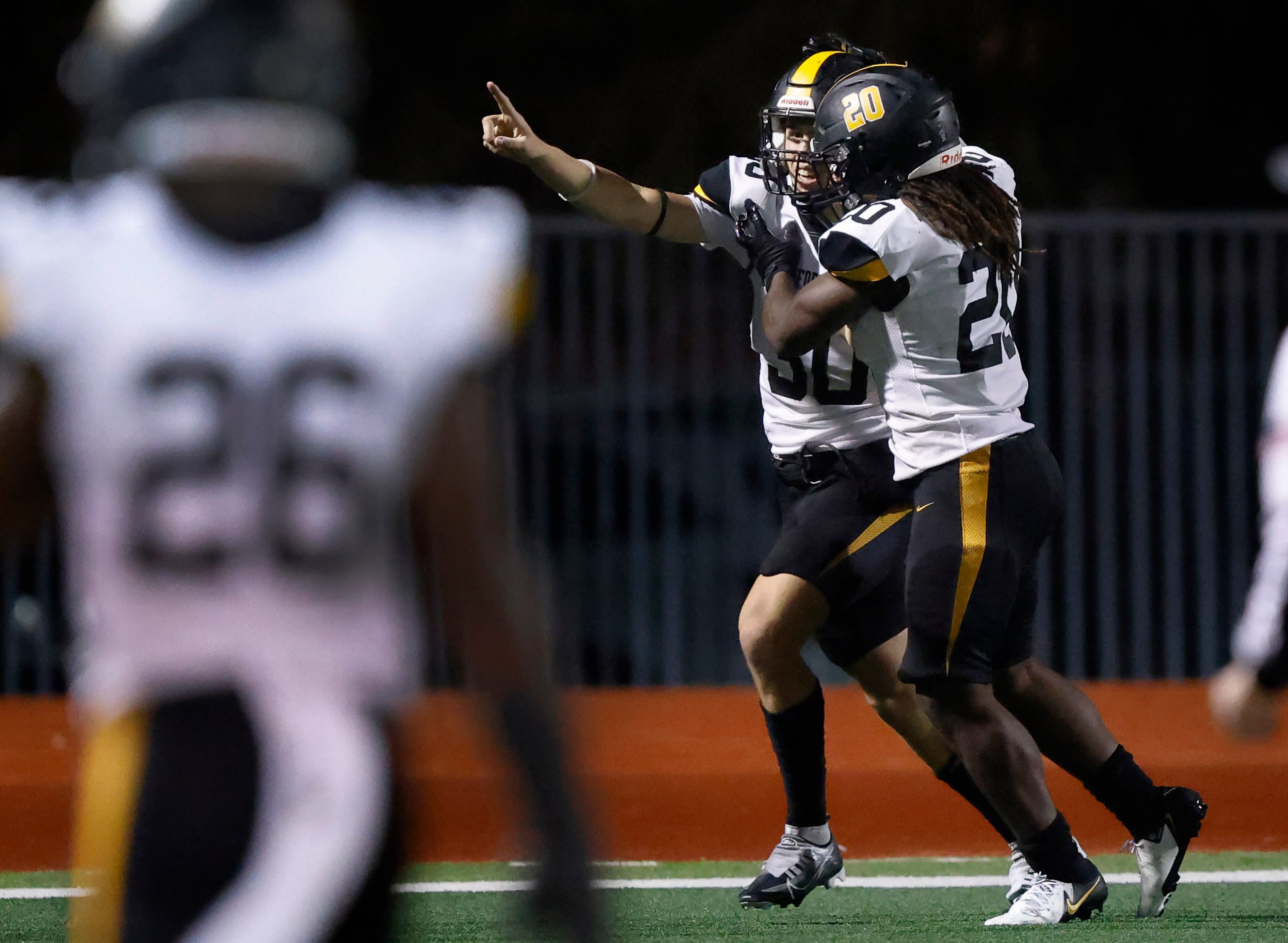 Forney linebacker Bryce Lott (30) is congratulated by teammate Xzavier Young (3) after...