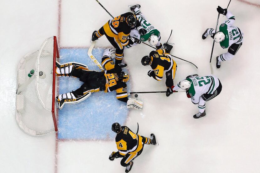 Pittsburgh Penguins goalie Marc-Andre Fleury (29) sprawls in the crease to cover a loose...
