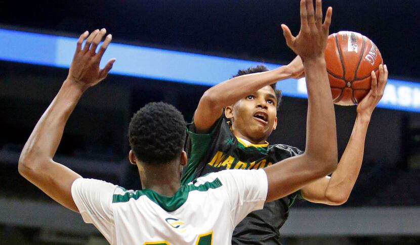 Madison's Jerome Rogers Jr. (#11) shoots over San Antonio Cole's Vincent Iwuchukwu (#24) at...