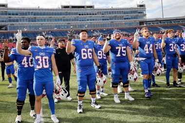 SMU players celebrate their victory against Navy after an NCAA college football game at...