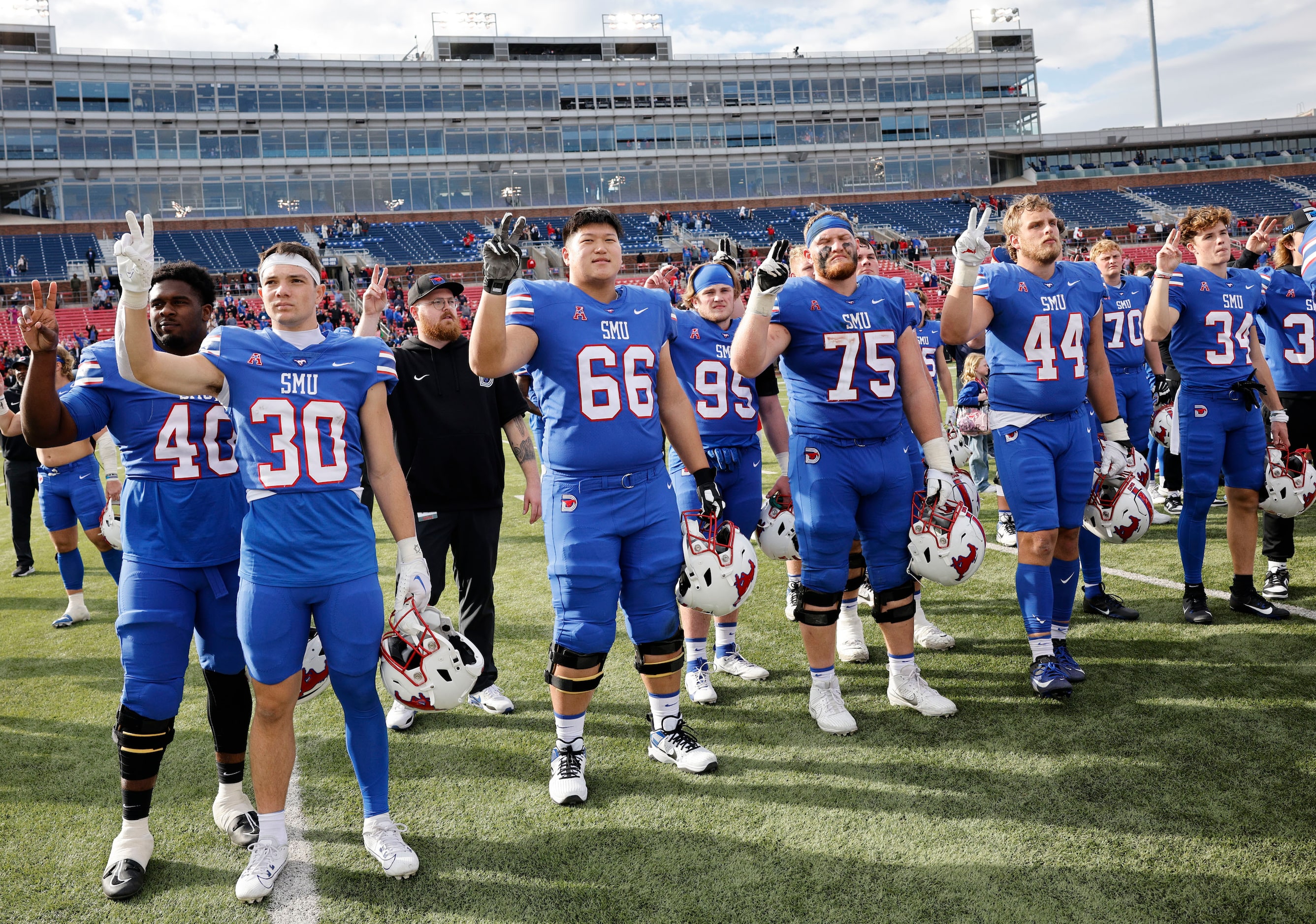 SMU players celebrate their victory against Navy after an NCAA college football game at...