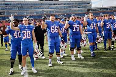 SMU players celebrate their victory against Navy after an NCAA college football game at...