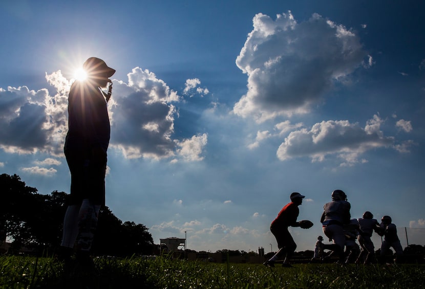 Spruce High School head football coach Carl Richardson coaches football practice on...