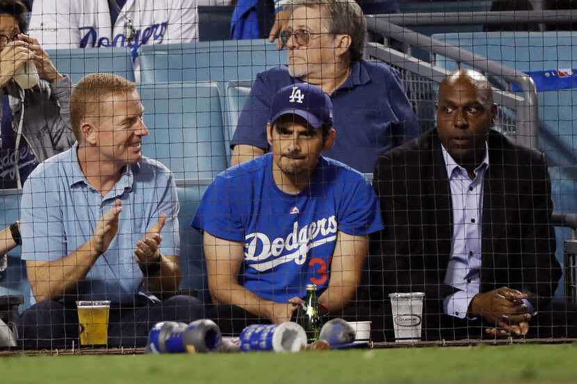 Country singer Brad Paisley (center) and Dallas Cowboy coach Jason Garrett watch Game 3 of...