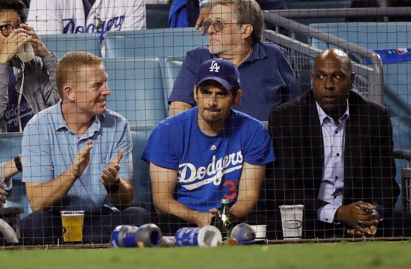 Country singer Brad Paisley (center) and Dallas Cowboy coach Jason Garrett watch Game 3 of...