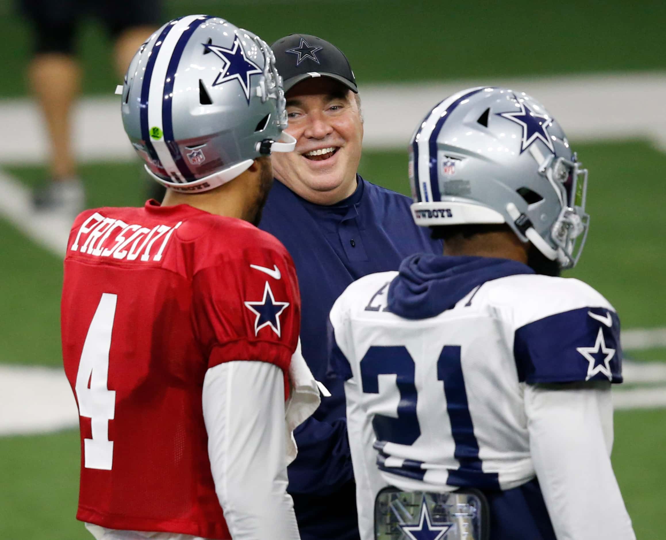 Dallas Cowboys head coach Mike McCarthy laughs as he talks with Dallas Cowboys quarterback...