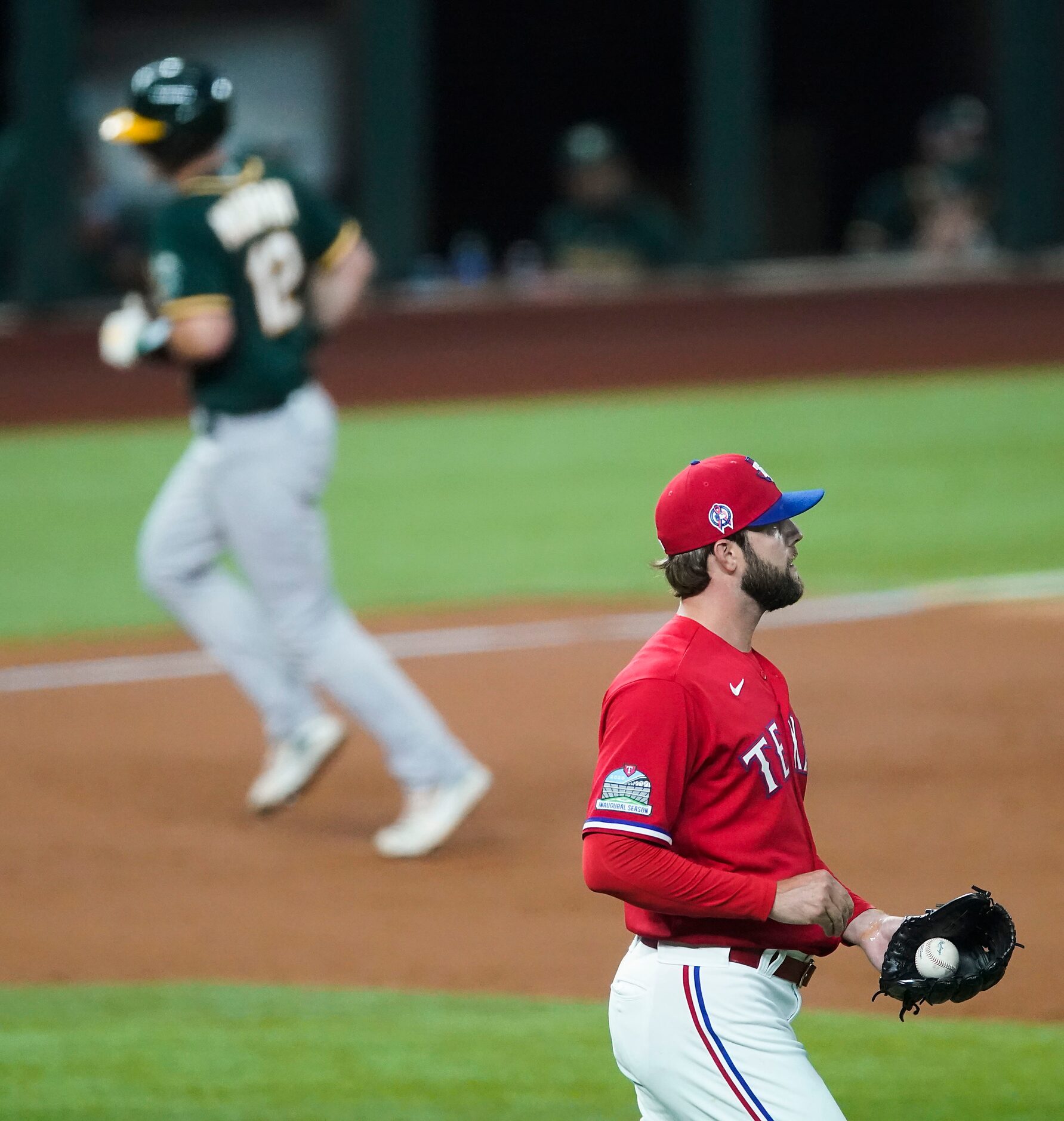 Texas Rangers pitcher Jordan Lyles looks away as Oakland Athletics catcher Sean Murphy...