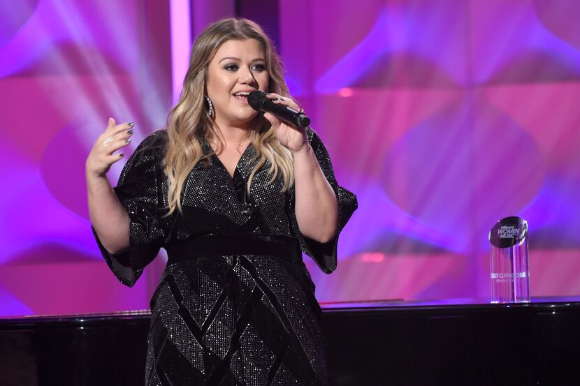 Kelly Clarkson accepts the powerhouse award at the Billboard Women in Music event at the Ray...
