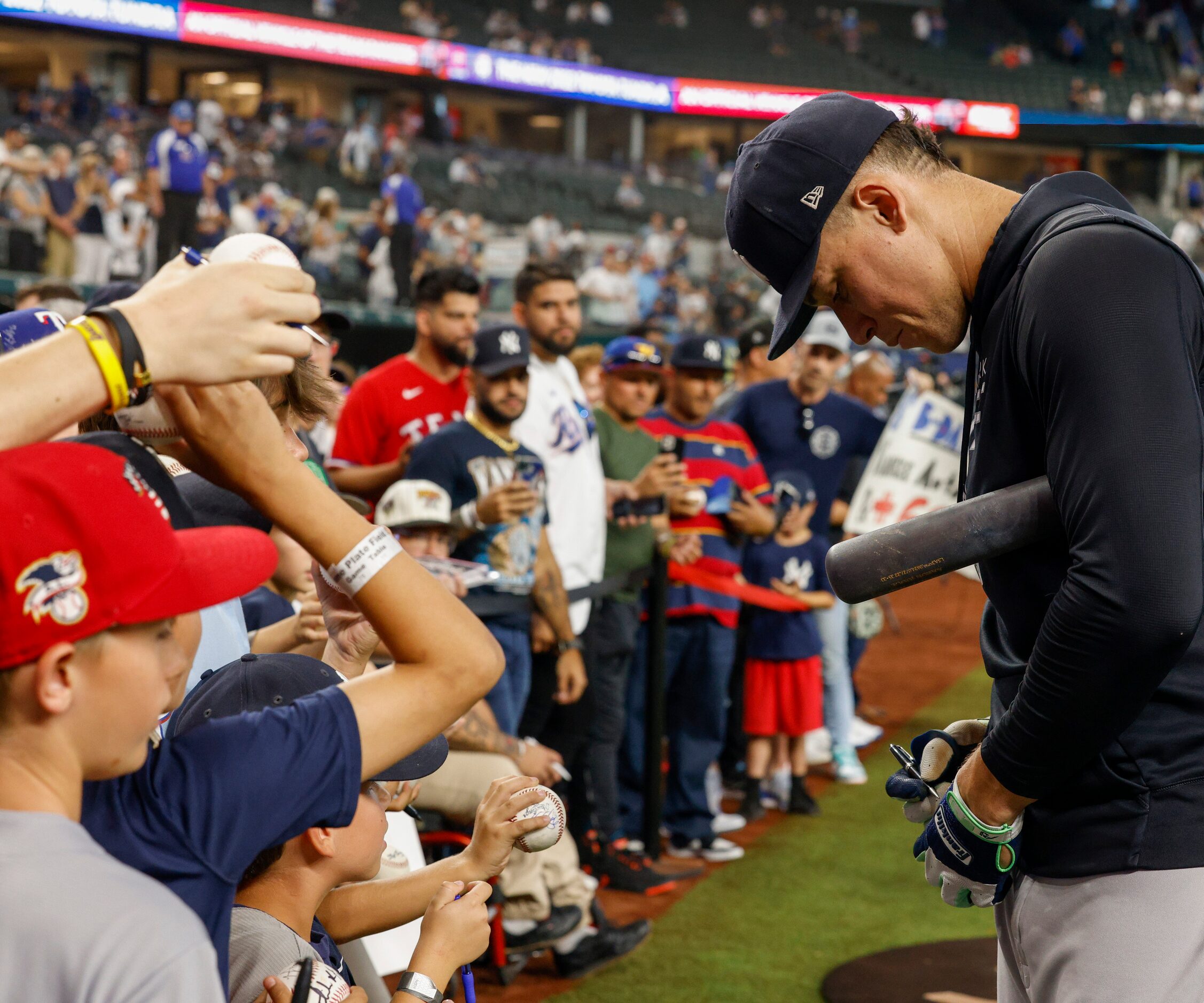 New York Yankees right fielder Aaron Judge (99) signs autographs during batting practice...