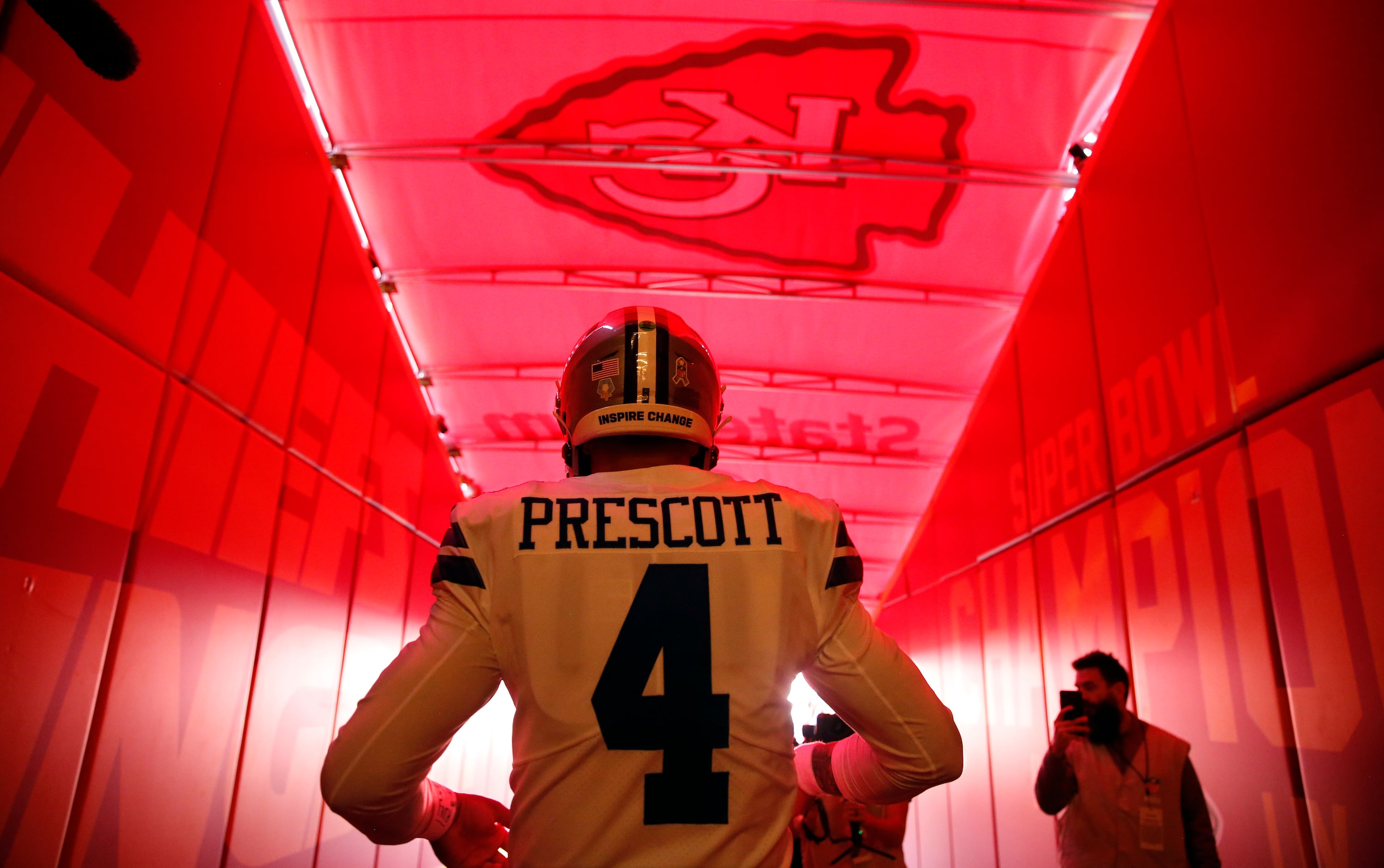 Dallas Cowboys quarterback Dak Prescott (4) walks to the field for pregame warmups before...