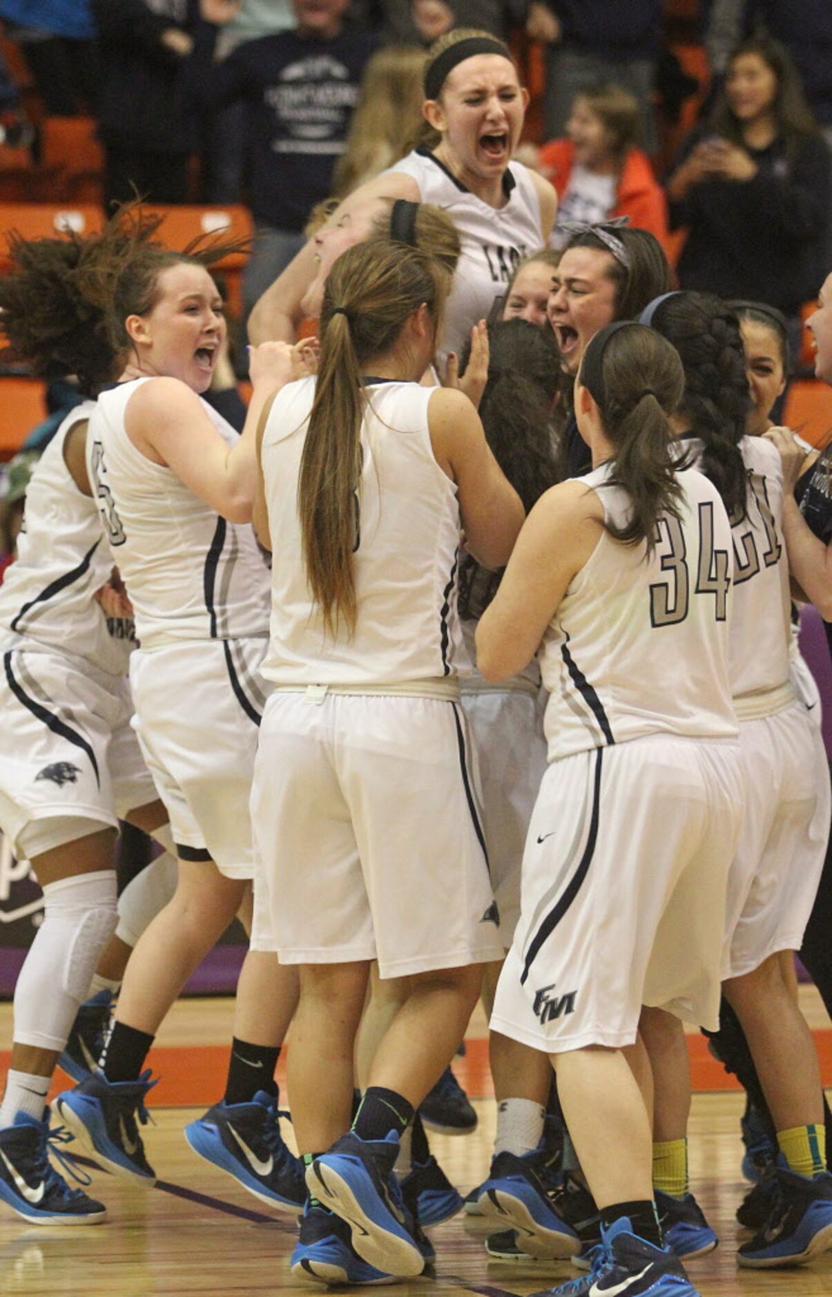 Flower Mound High School players celebrate their victory over Plano West in the Class 6A...