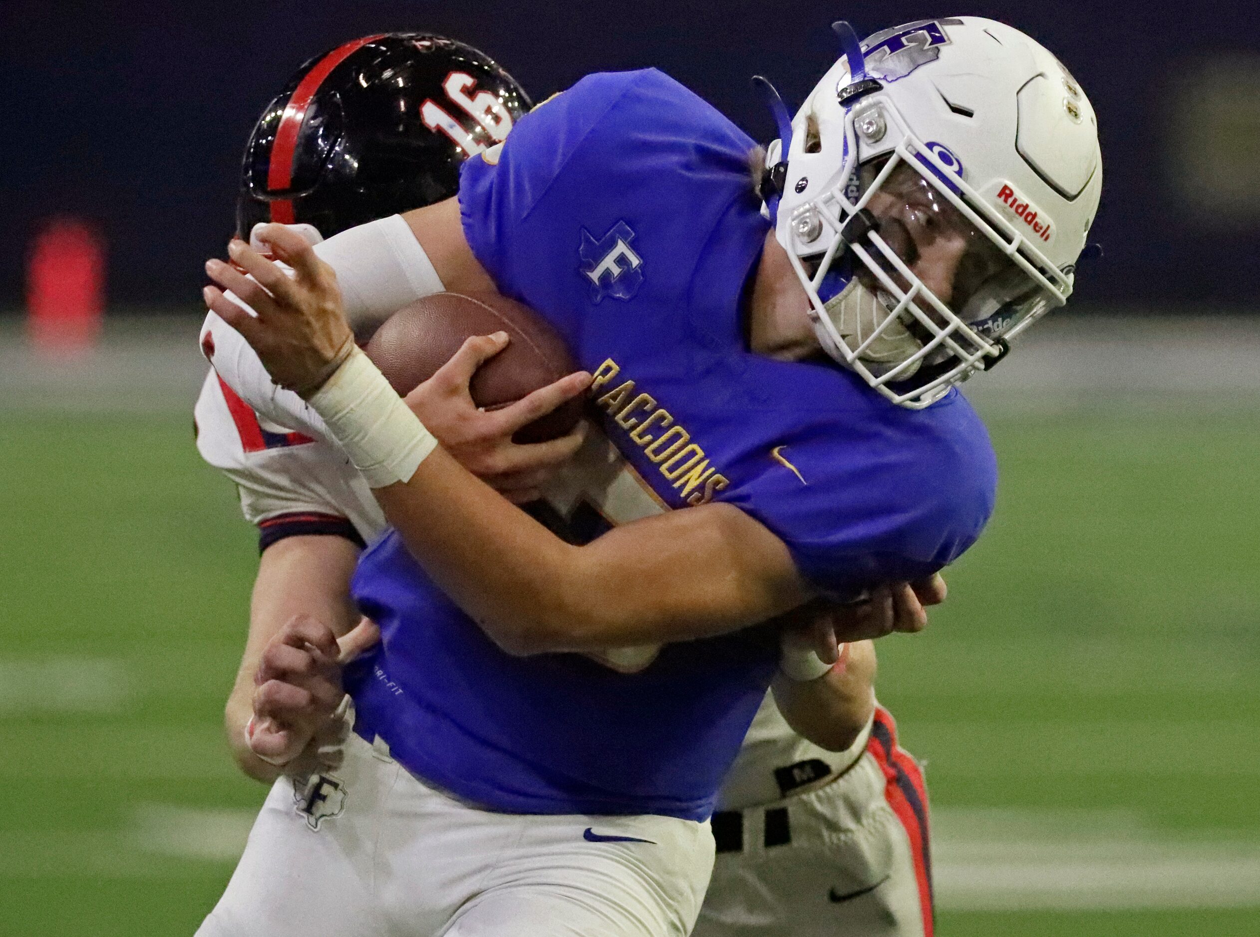 Frisco High School quarterback Cobyn Harbert (5) is taken out of bounds by Centennial High...