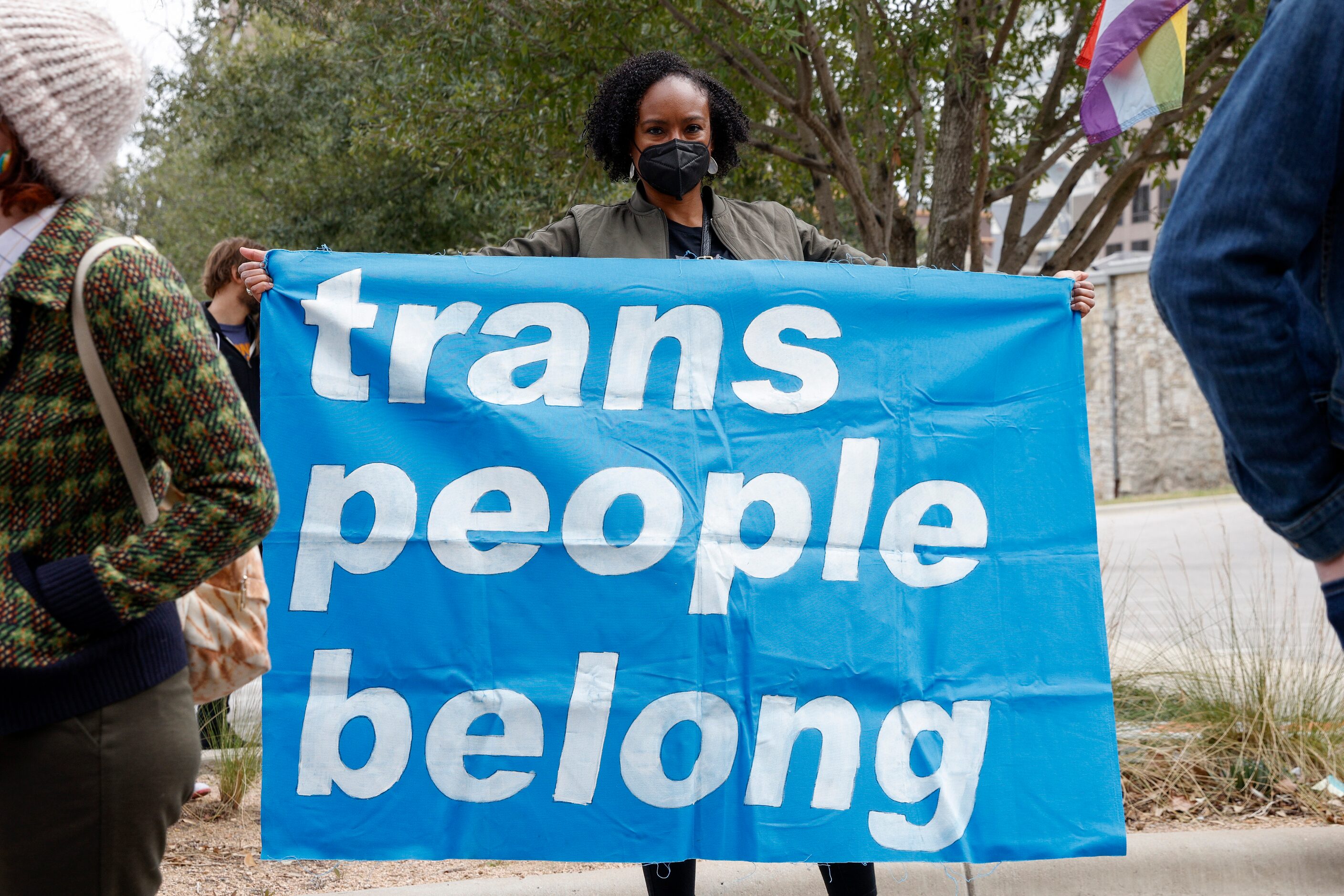 Oni Blair, ACLU of Texas executive director, holds a banner during the "Trans Kids Cry For...