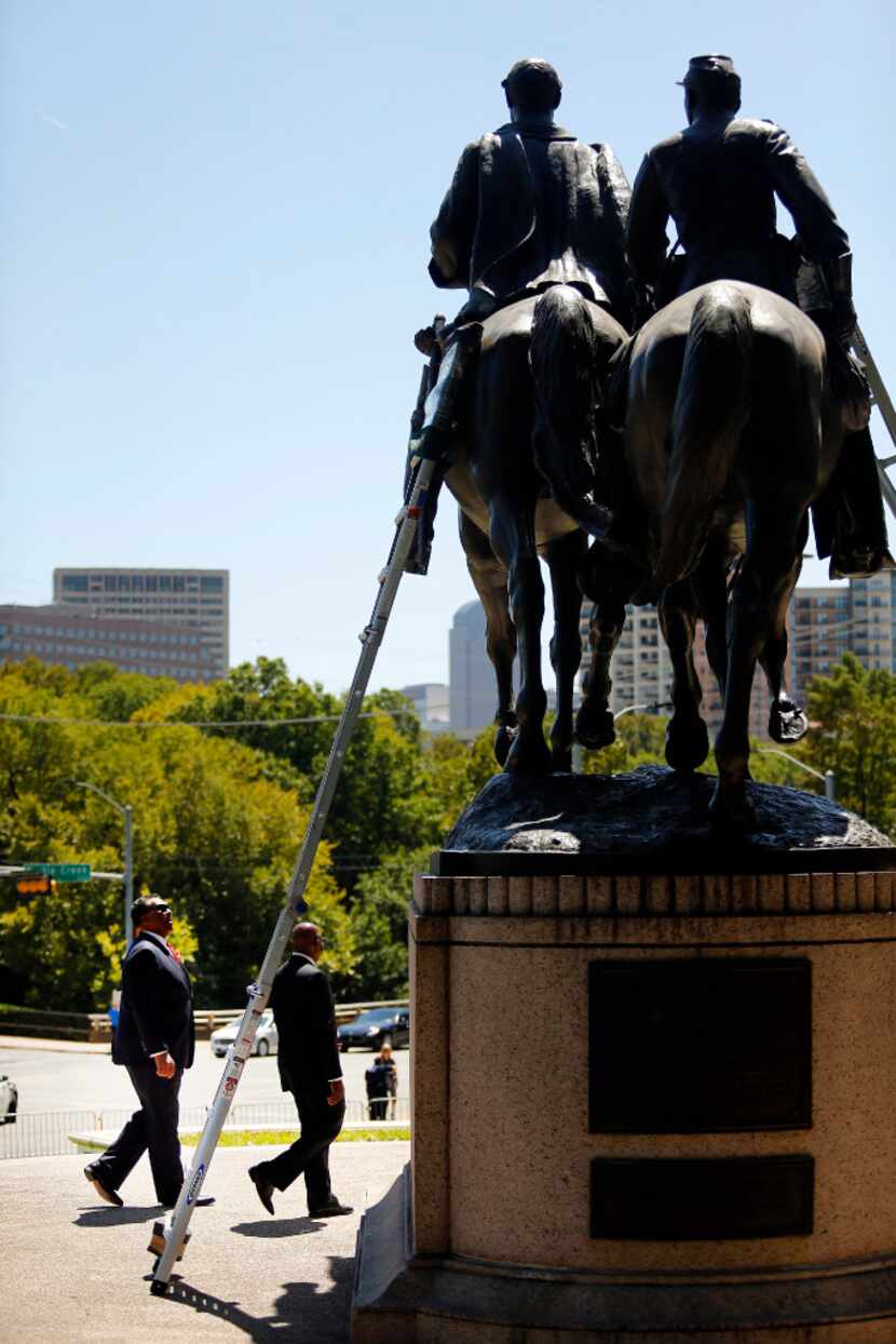 Dallas Councilman Dwaine Caraway (left) came to see the Robert E. Lee statue before it was...