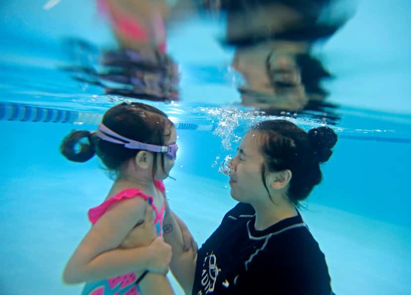 Olivia Lemmon, 2, gets a swim lesson to become comfortable underwater from instructor Monica...