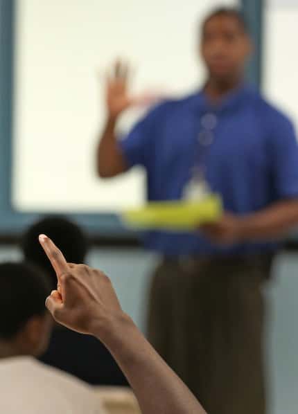 A juvenile offender raises his hand to ask a question during a group session, as seen during...